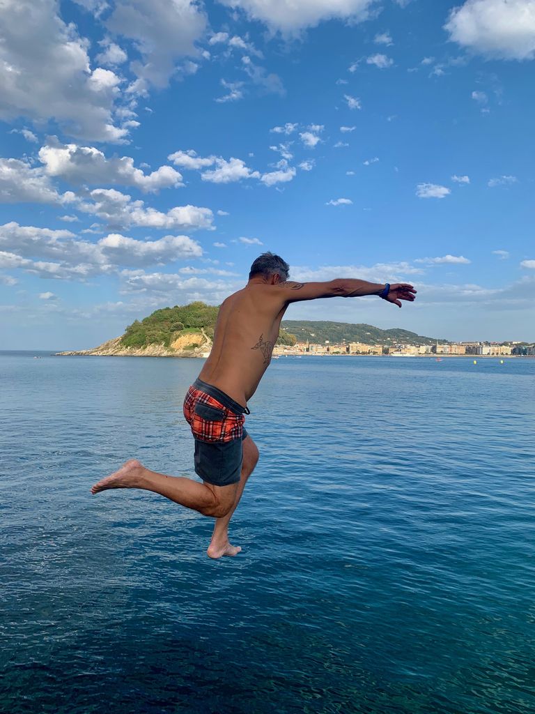 jumping into the sea in La Concha bay San Sebastian.