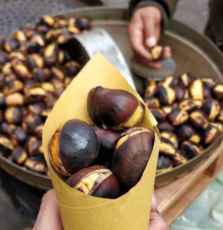 A paper cone of roasted chestnuts in San Sebastian